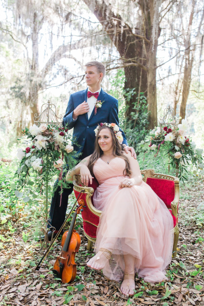 The bride and groom in their romantic boho wedding setting